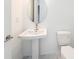 Small bathroom offering a pedestal sink and toilet with neutral flooring at 2492 Overfalls Pl, Wesley Chapel, FL 33543