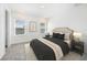 This bedroom offers a neutral color palette, a large bed, side tables, and natural light from the windows at 2492 Overfalls Pl, Wesley Chapel, FL 33543