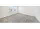 A bright bedroom is carpeted and has a window that allows for lots of natural light at 2492 Overfalls Pl, Wesley Chapel, FL 33543