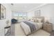Inviting bedroom showcasing an elegant decor, tray ceiling, and soft natural light for a serene retreat at 2492 Overfalls Pl, Wesley Chapel, FL 33543