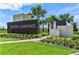 Landscaped entrance to River Landing featuring stone accents and lush landscaping at 2492 Overfalls Pl, Wesley Chapel, FL 33543