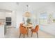 Bright breakfast nook with charming pendant lighting, cozy seating, and views of the backyard at 2492 Overfalls Pl, Wesley Chapel, FL 33543