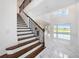 Bright foyer featuring staircase, marble flooring, and an open concept at 2492 Overfalls Pl, Wesley Chapel, FL 33543