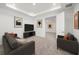 Relaxing living room with comfortable seating, a mounted television, and stylish movie-themed decor at 2492 Overfalls Pl, Wesley Chapel, FL 33543