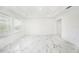 Bright and open floor plan living room with plenty of natural light and marble flooring at 2492 Overfalls Pl, Wesley Chapel, FL 33543