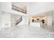 Spacious living area with soaring ceilings, marble floors, iron stair railing, and modern open floor plan at 2492 Overfalls Pl, Wesley Chapel, FL 33543