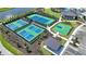 Aerial view of tennis and basketball courts for community recreation, adjacent to a parking area at 2492 Overfalls Pl, Wesley Chapel, FL 33543