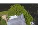 Aerial view of home showing roof, backyard, mature trees, and canal access, highlighting the property's location at 33 Cypress Dr, Palm Harbor, FL 34684