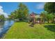 Waterfront home with large backyard, covered patio, and canal access, perfect for outdoor entertaining at 33 Cypress Dr, Palm Harbor, FL 34684