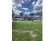 Spacious backyard with waterfront view and ample greenery, offering a serene outdoor setting at 33 Cypress Dr, Palm Harbor, FL 34684
