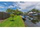 Waterfront property with green grass, canal access and boat dock, ideal for boating enthusiasts at 33 Cypress Dr, Palm Harbor, FL 34684