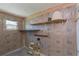 Partially finished basement with updated electrical, shelving, and a window at 33 Cypress Dr, Palm Harbor, FL 34684