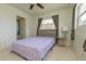 A comfortable bedroom featuring a large window, ceiling fan, and a side table at 33 Cypress Dr, Palm Harbor, FL 34684