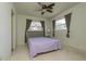 Cozy bedroom featuring two windows and a ceiling fan to enhance comfort at 33 Cypress Dr, Palm Harbor, FL 34684