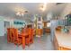 This bright dining area features a wooden table and chairs adjacent to an open-concept kitchen at 33 Cypress Dr, Palm Harbor, FL 34684