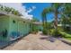 Inviting exterior featuring a well-maintained yard, mature landscaping, and a cozy seating area at 33 Cypress Dr, Palm Harbor, FL 34684