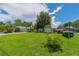Home exterior with a lush green lawn and ample parking for vehicles and boats, perfect for outdoor living at 33 Cypress Dr, Palm Harbor, FL 34684