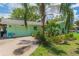 Charming one-story home with a lushly landscaped yard and driveway at 33 Cypress Dr, Palm Harbor, FL 34684