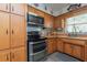 Charming kitchen featuring wooden cabinetry, stainless steel appliances, and butcher block counters at 33 Cypress Dr, Palm Harbor, FL 34684