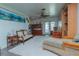 Bright living room with white rug, unique fan, and sliding doors to the outside at 33 Cypress Dr, Palm Harbor, FL 34684