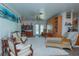 Bright living room with white rug, unique fan, and sliding doors to the outside at 33 Cypress Dr, Palm Harbor, FL 34684