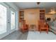 Living room featuring hard wood floors, wooden chairs, built in cabinet, and glass door to outside at 33 Cypress Dr, Palm Harbor, FL 34684