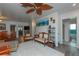 Bright living room featuring a unique fan, wood floors and decor with access to multiple rooms at 33 Cypress Dr, Palm Harbor, FL 34684