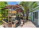 Well-equipped outdoor kitchen with grill, counter space, and shaded area, ideal for al fresco dining at 33 Cypress Dr, Palm Harbor, FL 34684