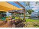 Cozy patio with covered swing and canal view for peaceful relaxation and outdoor enjoyment at 33 Cypress Dr, Palm Harbor, FL 34684