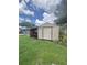 Outdoor shed providing extra storage space for tools, equipment, and outdoor essentials in the backyard at 33 Cypress Dr, Palm Harbor, FL 34684