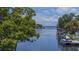 Scenic water view with boat, dock, and lush green trees, offering a tranquil and picturesque setting at 33 Cypress Dr, Palm Harbor, FL 34684