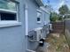 Exterior showcasing the home's cooling system and well-maintained facade at 3927 Huntington Ne St, St Petersburg, FL 33703