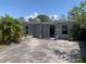 Charming single-story home with a paved driveway and covered entrance at 3927 Huntington Ne St, St Petersburg, FL 33703