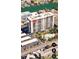 Aerial view of a condo building with a pool and parking area at 400 Island Way # 1606, Clearwater Beach, FL 33767