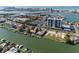 Aerial view of waterfront condominiums with docks and boats along the water's edge at 400 Island Way # 1606, Clearwater Beach, FL 33767