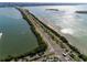 Aerial view of a multi-lane road with water on both sides with lush landscaping at 400 Island Way # 1606, Clearwater Beach, FL 33767
