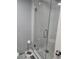 Clean white tiled shower with glass door and modern hardware fixtures at 400 Island Way # 1606, Clearwater Beach, FL 33767