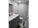 Neutral half-bathroom with gray vanity, square mirror, and neutral color scheme at 400 Island Way # 1606, Clearwater Beach, FL 33767