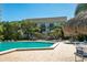 Community pool and building, accented by tropical plants and a tiki hut at 400 Island Way # 1606, Clearwater Beach, FL 33767