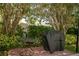 Charming patio with a small table and grill, surrounded by lush landscaping at 400 Island Way # 1606, Clearwater Beach, FL 33767