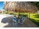 Relaxing outdoor seating and tiki umbrellas by the community pool at 400 Island Way # 1606, Clearwater Beach, FL 33767