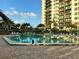 Outdoor pool with lounge chairs and a view of the condominium building at 400 Island Way # 1606, Clearwater Beach, FL 33767