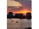 Beautiful sunset view over the water with buildings and boats in the foreground at 400 Island Way # 1606, Clearwater Beach, FL 33767