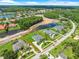 Expansive aerial view of the property with lush lawn, a circular driveway, and a view of the water at 4521 Cheval Blvd, Lutz, FL 33558