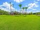 Large grassy backyard with a screened in lanai and mature trees for privacy, with a home set back from view at 4521 Cheval Blvd, Lutz, FL 33558