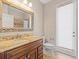 Bathroom with granite vanity, wood cabinets, and tiled floors at 4521 Cheval Blvd, Lutz, FL 33558