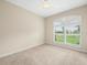 Neutral bedroom with a ceiling fan and a large window providing natural light at 4521 Cheval Blvd, Lutz, FL 33558