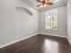 Bedroom with hardwood floors, crown molding, arched niche, and a window with plantation shutters at 4521 Cheval Blvd, Lutz, FL 33558