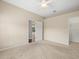 Spacious bedroom with carpet, a ceiling fan, and entry to other rooms at 4521 Cheval Blvd, Lutz, FL 33558
