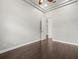 Bright bedroom features hardwood floors, tray ceiling, and white trim at 4521 Cheval Blvd, Lutz, FL 33558